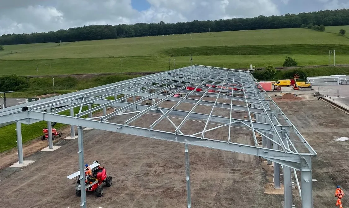 Steel frame of a large shed in a rural field